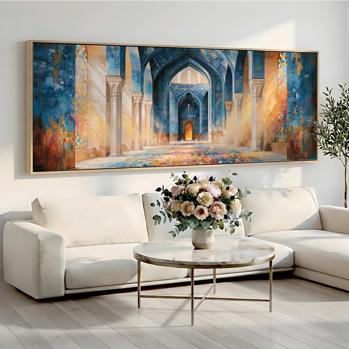 a large, colorful painting of an ornate, arched doorway with intricate details, hanging on a wall above a white sofa and a round coffee table with a vase of flowers.