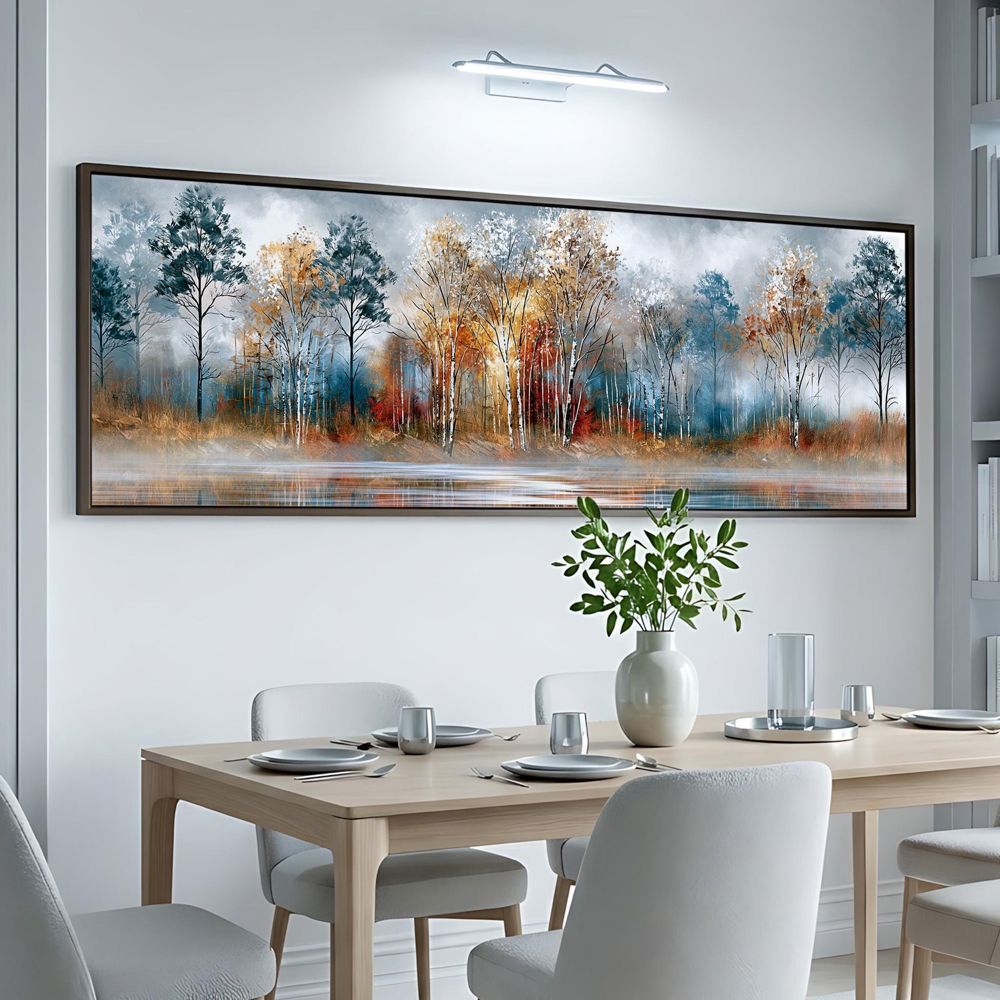 a dining room with a large, framed painting of a forest landscape hanging on the wall above a table set for a meal.