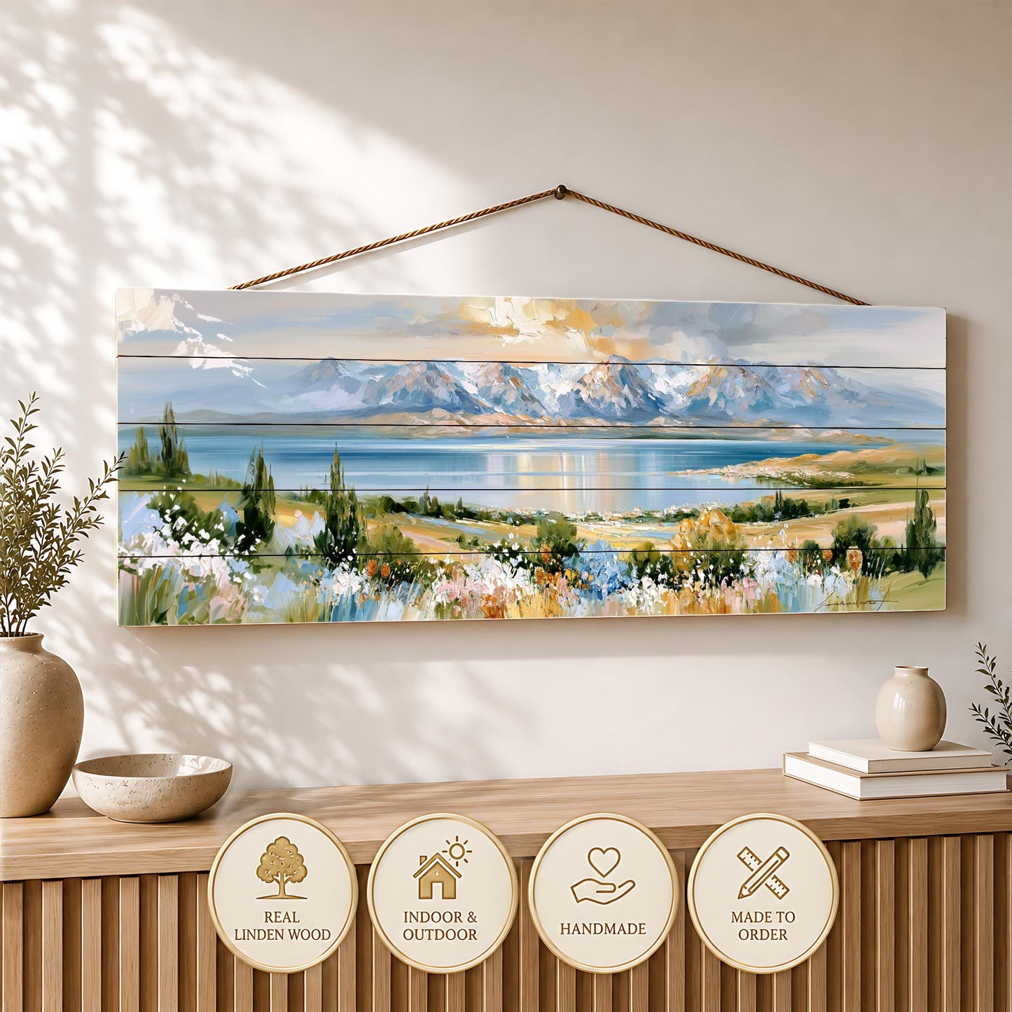 a large painting of a scenic landscape hanging on a wall, with a wooden shelf below it displaying decorative items.