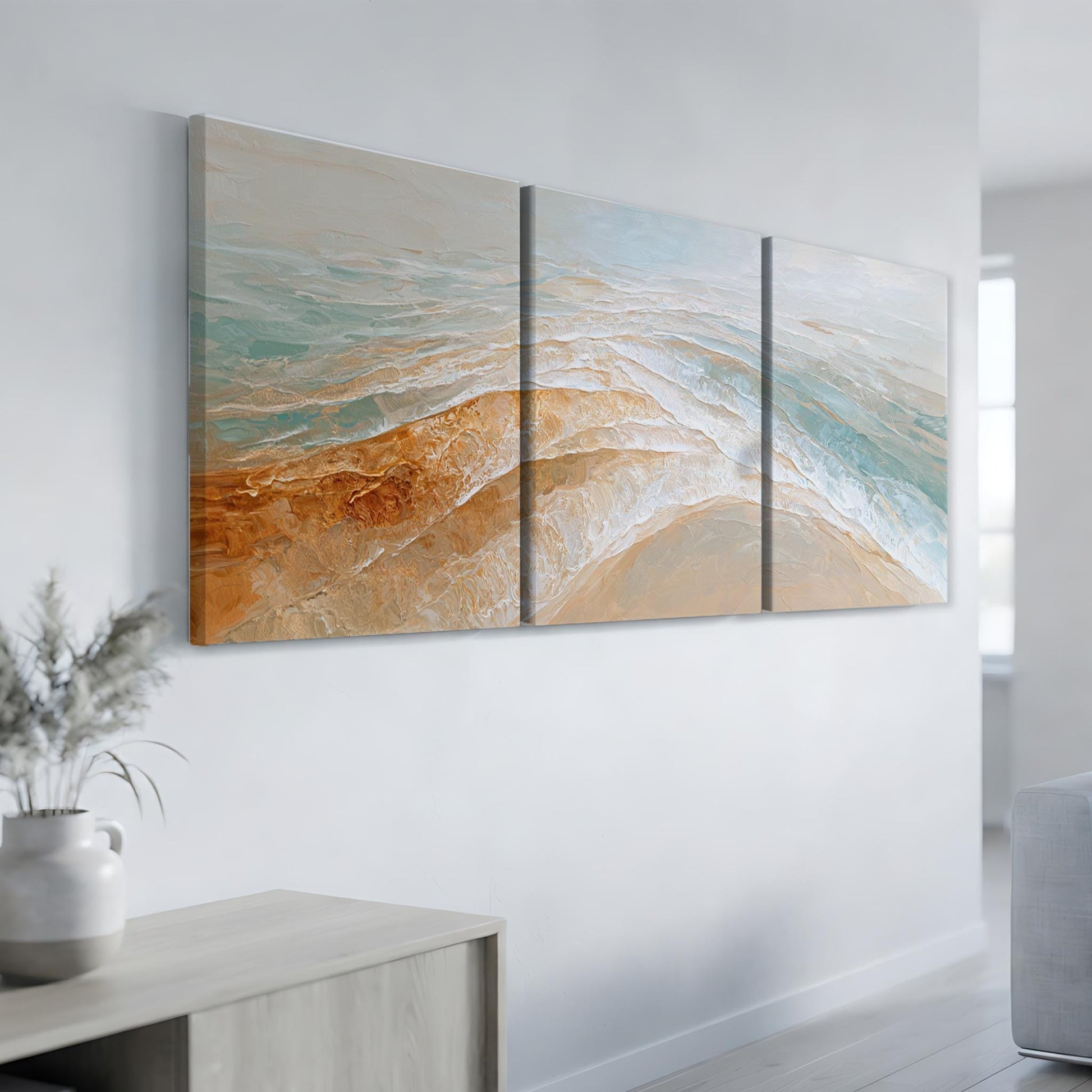 a large, three-panel painting hanging on a white wall in a modern living room.
