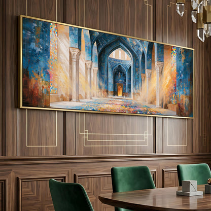 a large, ornate painting of an architectural structure, likely a mosque, hanging on a wooden wall. The painting is framed in gold and is the focal point of the room. In the foreground, there is a dining table with green chairs around it, suggesting a dining or meeting area.