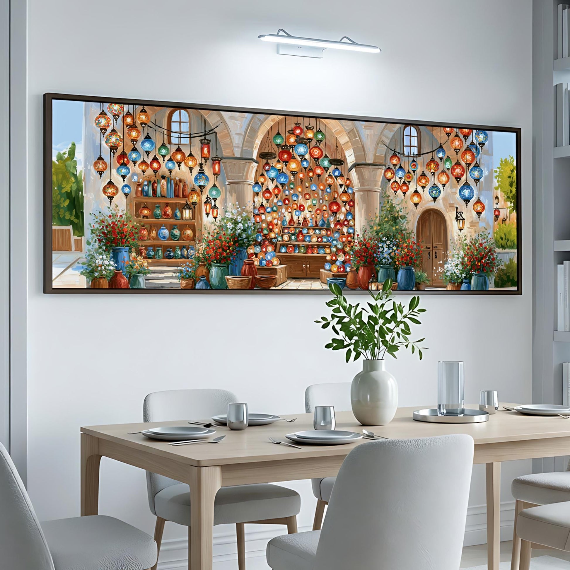 a dining room with a large, colorful painting of a building and lanterns hanging above a table set for a meal.