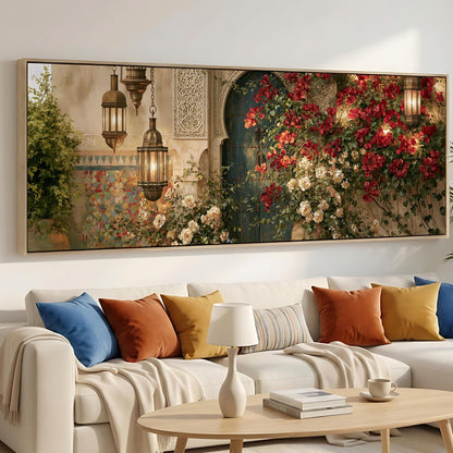 a large, colorful painting of a garden scene with red flowers and lush greenery, hanging on a wall above a white sofa with colorful throw pillows.