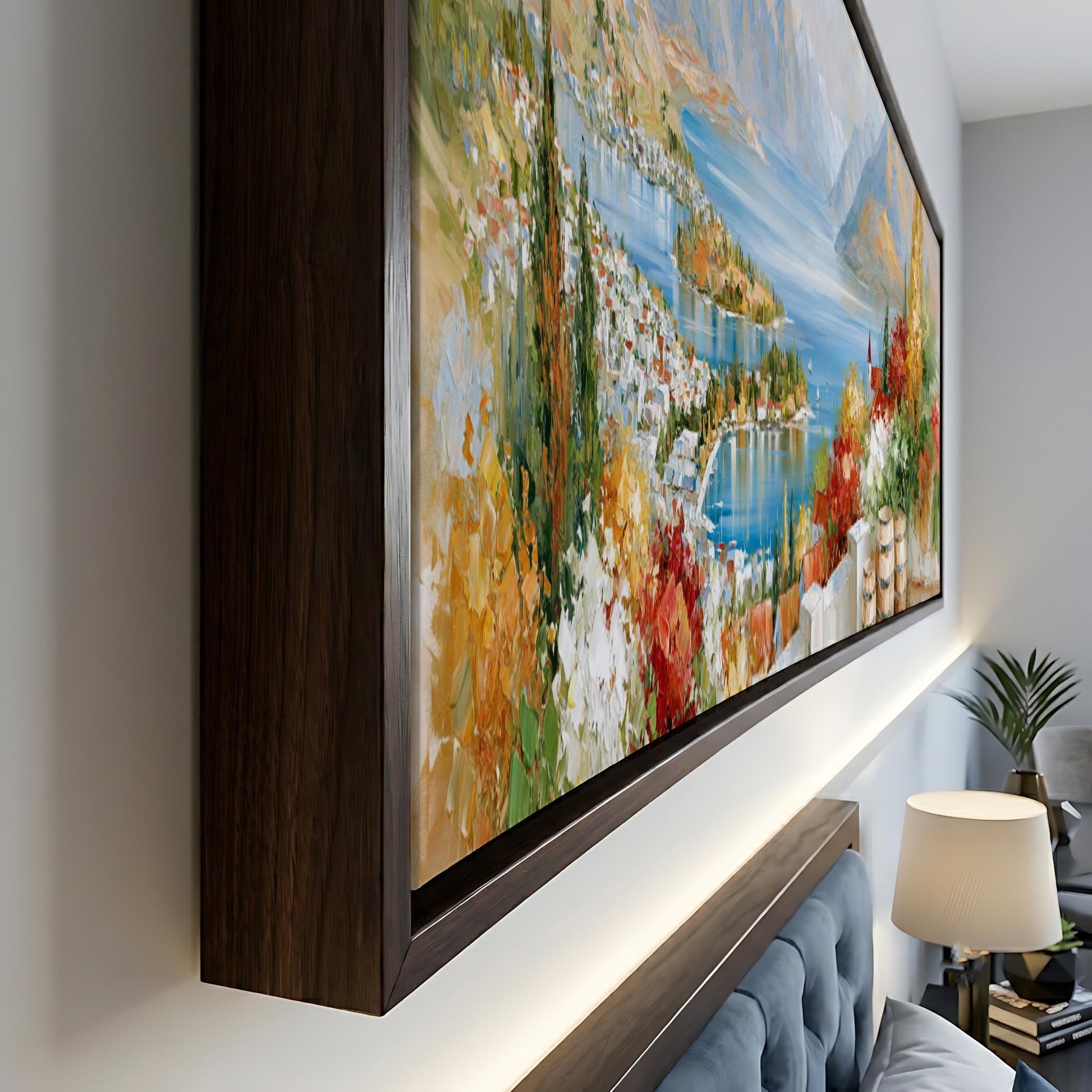 a large, colorful painting of a scenic landscape, including mountains, a lake, and a forest, hanging on a wall in a room.