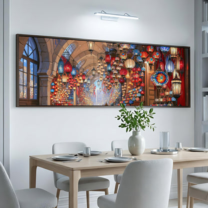 a dining room with a large, colorful painting of a lantern-filled room hanging on the wall above a table set for a meal.