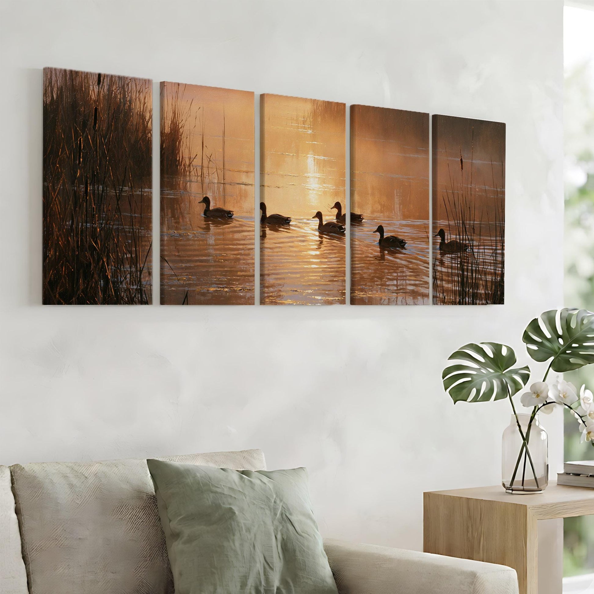 A wall art collage depicting ducks swimming in a pond at sunset, with warm orange and yellow hues reflecting on the water.