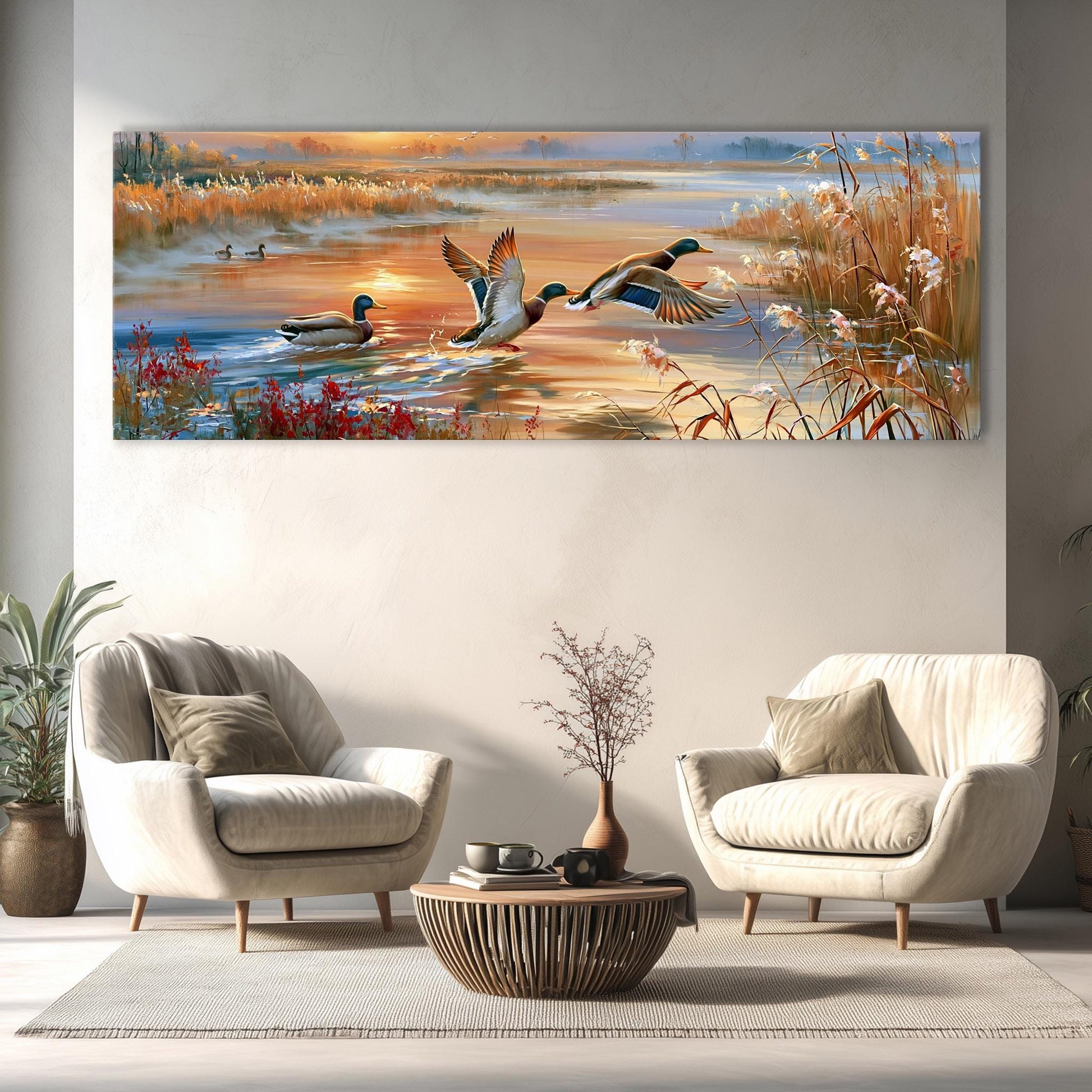 a large painting of ducks flying over a body of water, with a serene landscape in the background. The painting is hung on a wall above a seating area with two white armchairs and a coffee table.