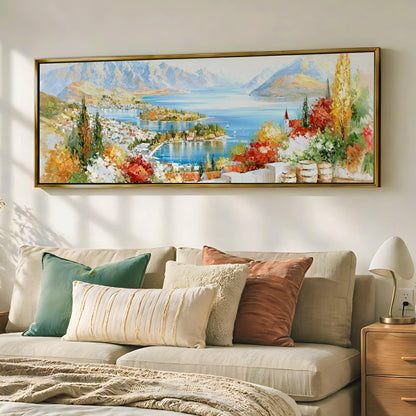 a large, colorful painting of a scenic landscape hanging on a wall above a beige couch with various pillows.