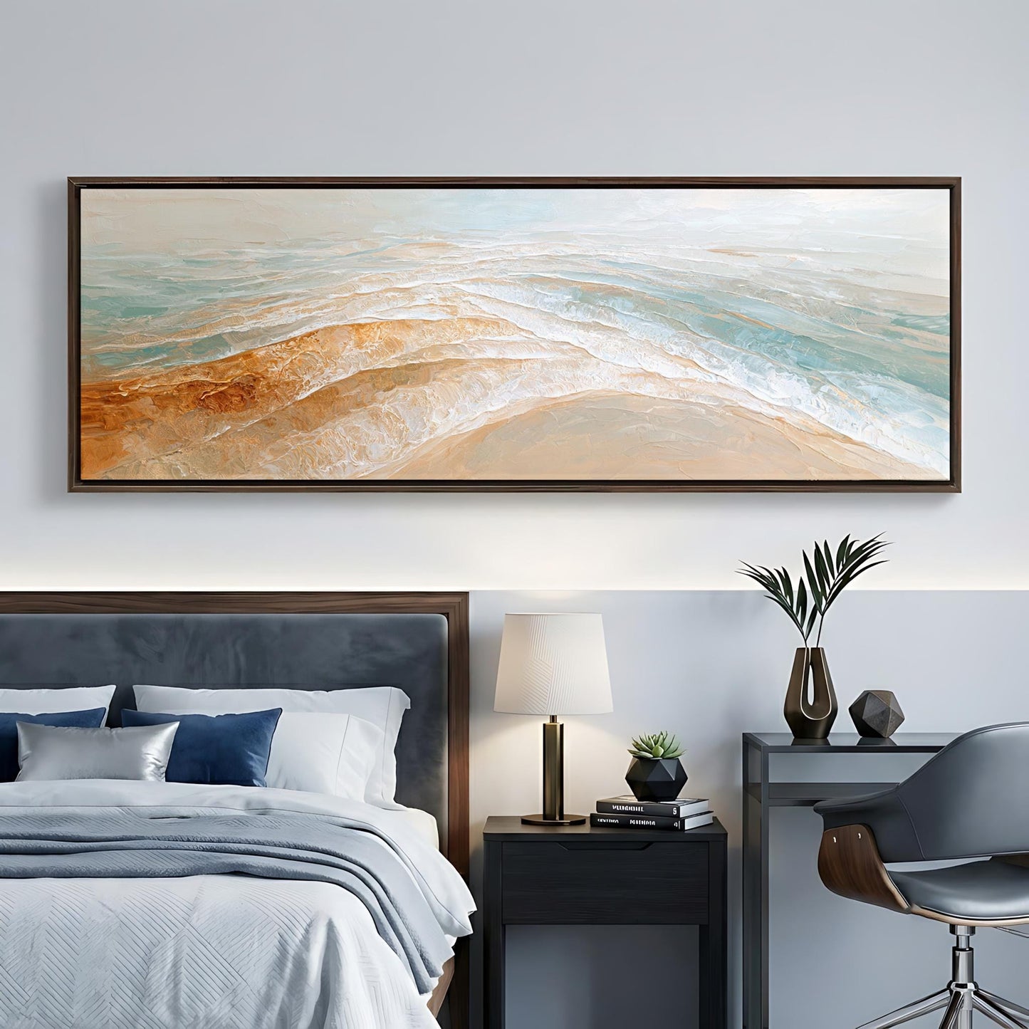a modern bedroom with a large painting of a beach scene hanging on the wall above a bed with a gray headboard. The room also includes a nightstand with a lamp, a desk with a plant, and a chair.