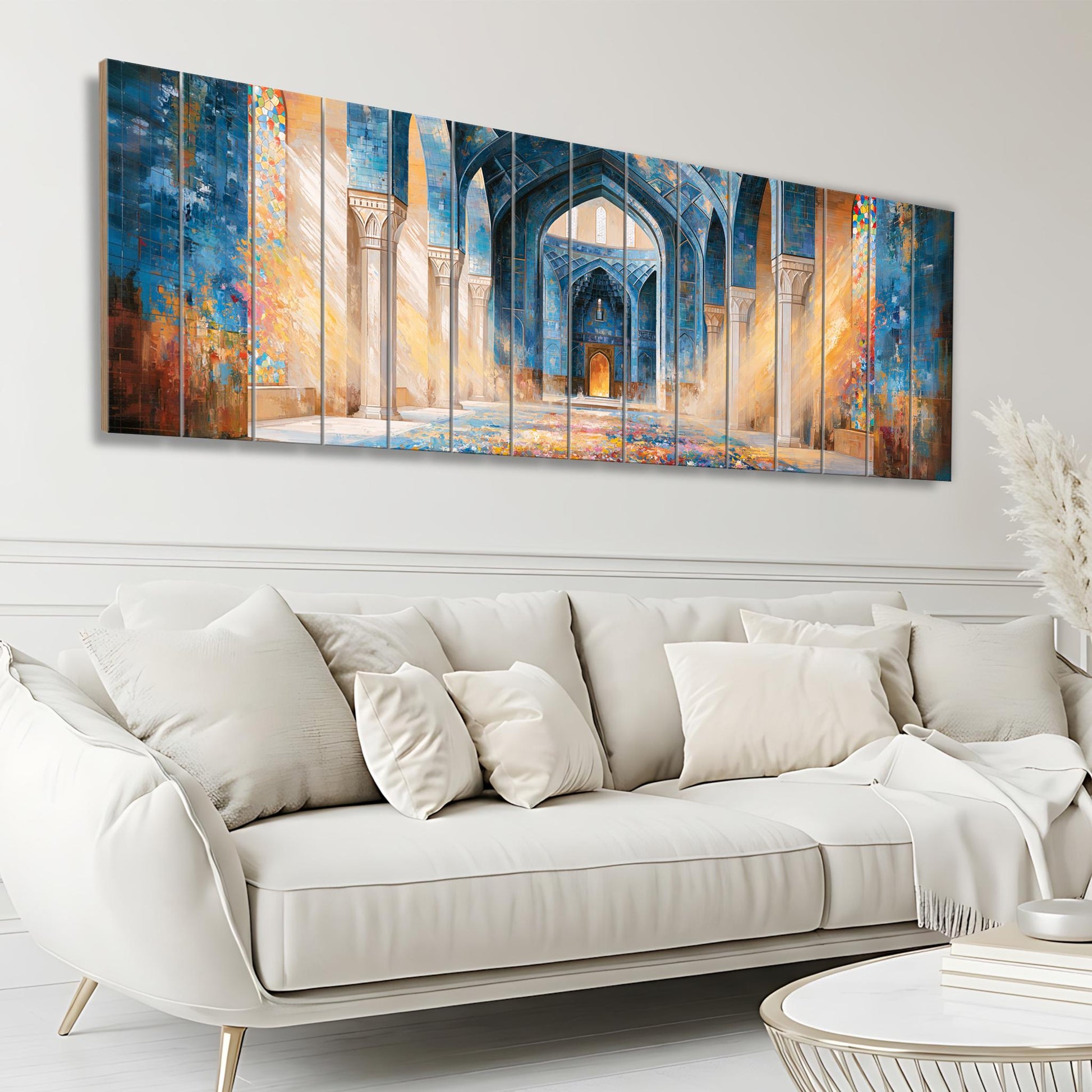 a large, colorful painting of an ornate, blue-colored archway or doorway, which is displayed on a wall above a white sofa in a living room setting.