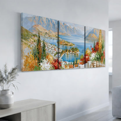 a large, colorful painting of a scenic landscape with mountains, a lake, and a town in the background.