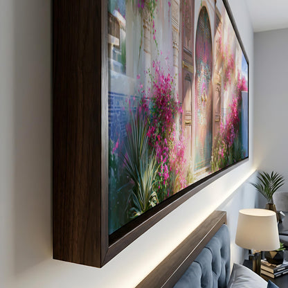 a large, framed painting of a garden scene with pink flowers and a colorful archway.