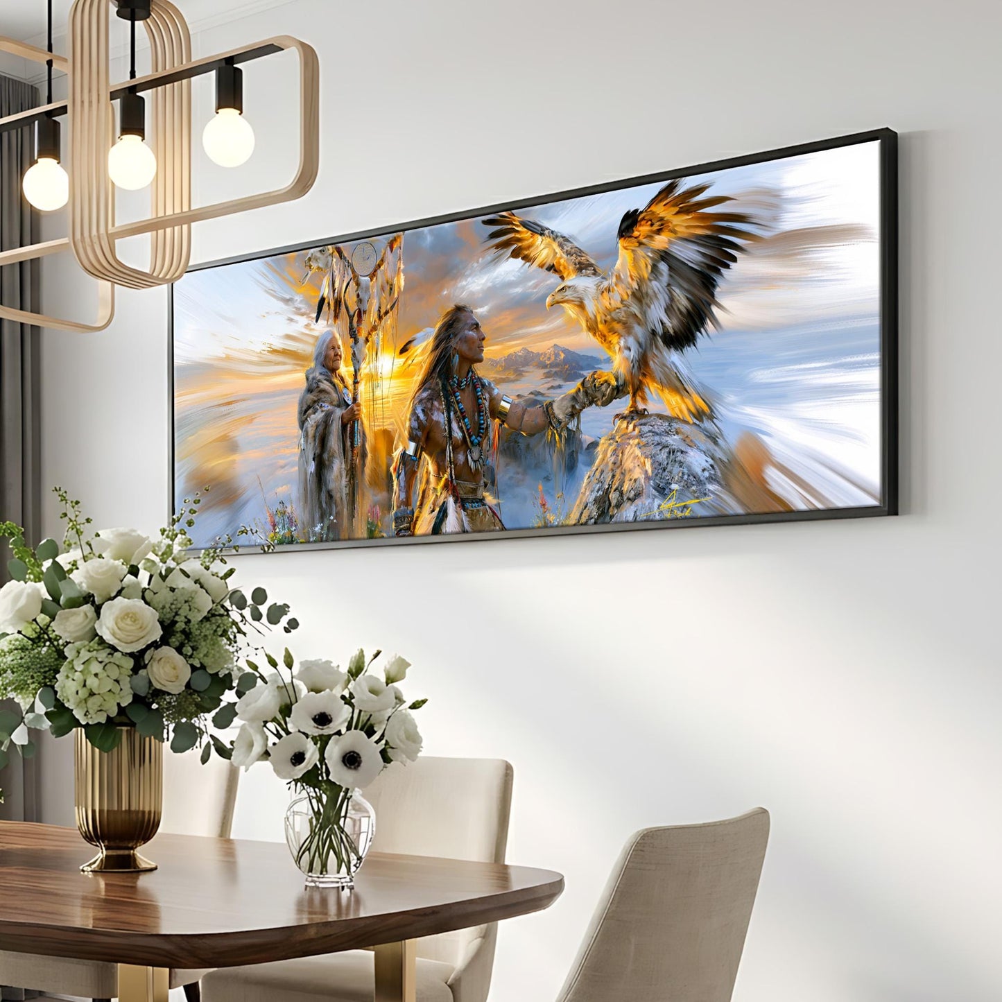 a large framed painting of a Native American woman with a bird of prey, such as an eagle, on her back, set against a colorful, dreamlike background. The painting is hanging on a wall above a dining table with a vase of white flowers on it.