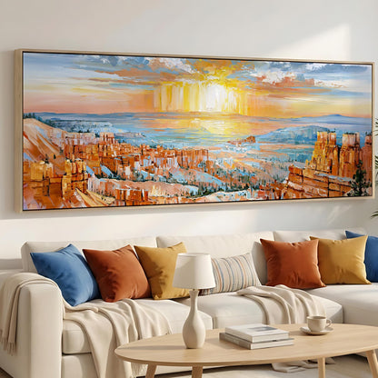 a large, colorful painting of a desert landscape hanging on a wall above a white couch with colorful throw pillows.
