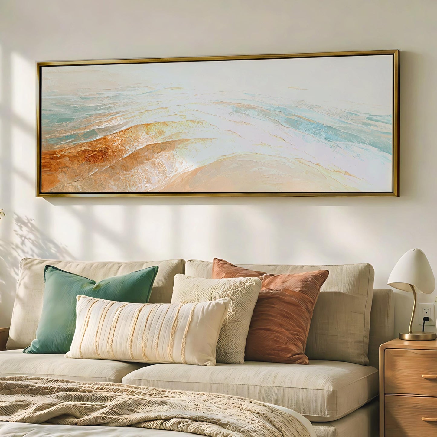 a cozy living room with a large, colorful painting hanging on the wall above a beige sofa adorned with throw pillows.