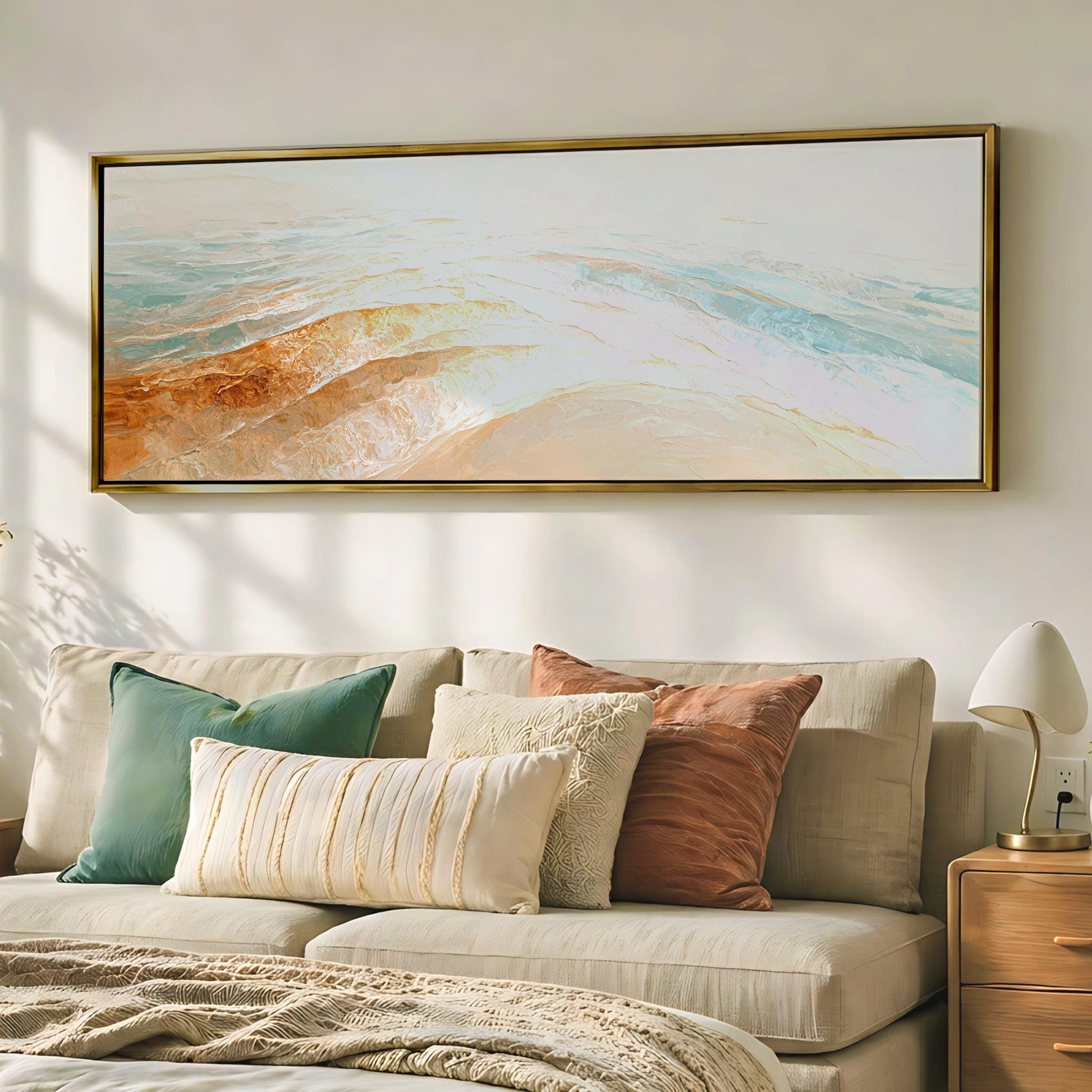 a cozy living room with a large, colorful painting hanging on the wall above a beige sofa adorned with throw pillows.