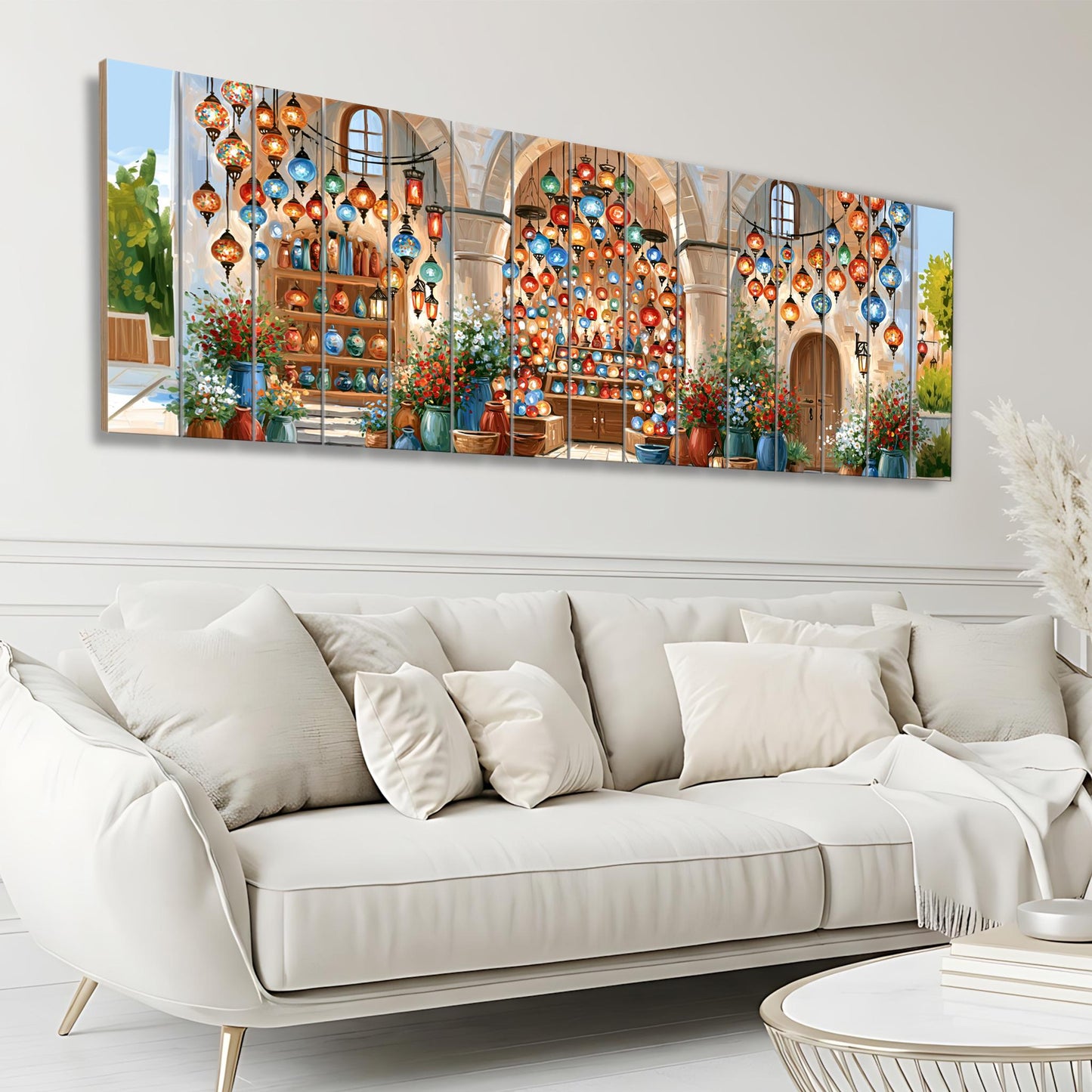 a large, colorful painting of a building with hanging lanterns, displayed on a wall above a white sofa in a living room setting.
