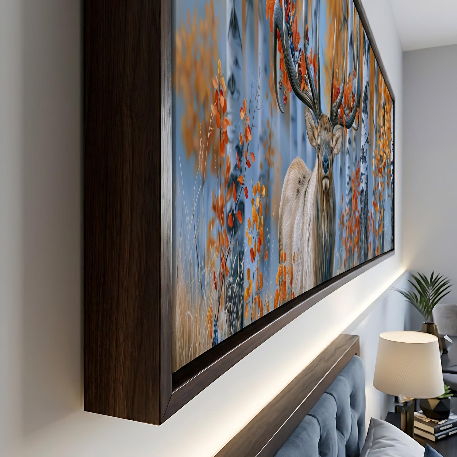 a large framed painting of a deer with antlers, displayed on a wall in a room.