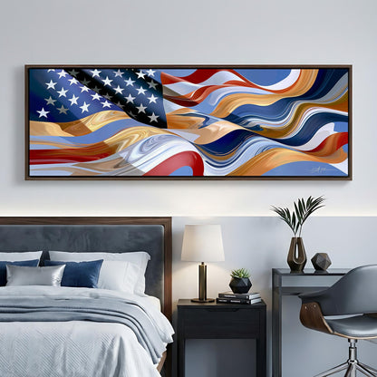 a large, abstract painting of the American flag hanging on a wall above a bed with a gray headboard. The painting has a vibrant, swirling design that resembles the colors and patterns of the flag. The room also includes a nightstand with a lamp, a chair, and some decorative items such as a vase and a plant.