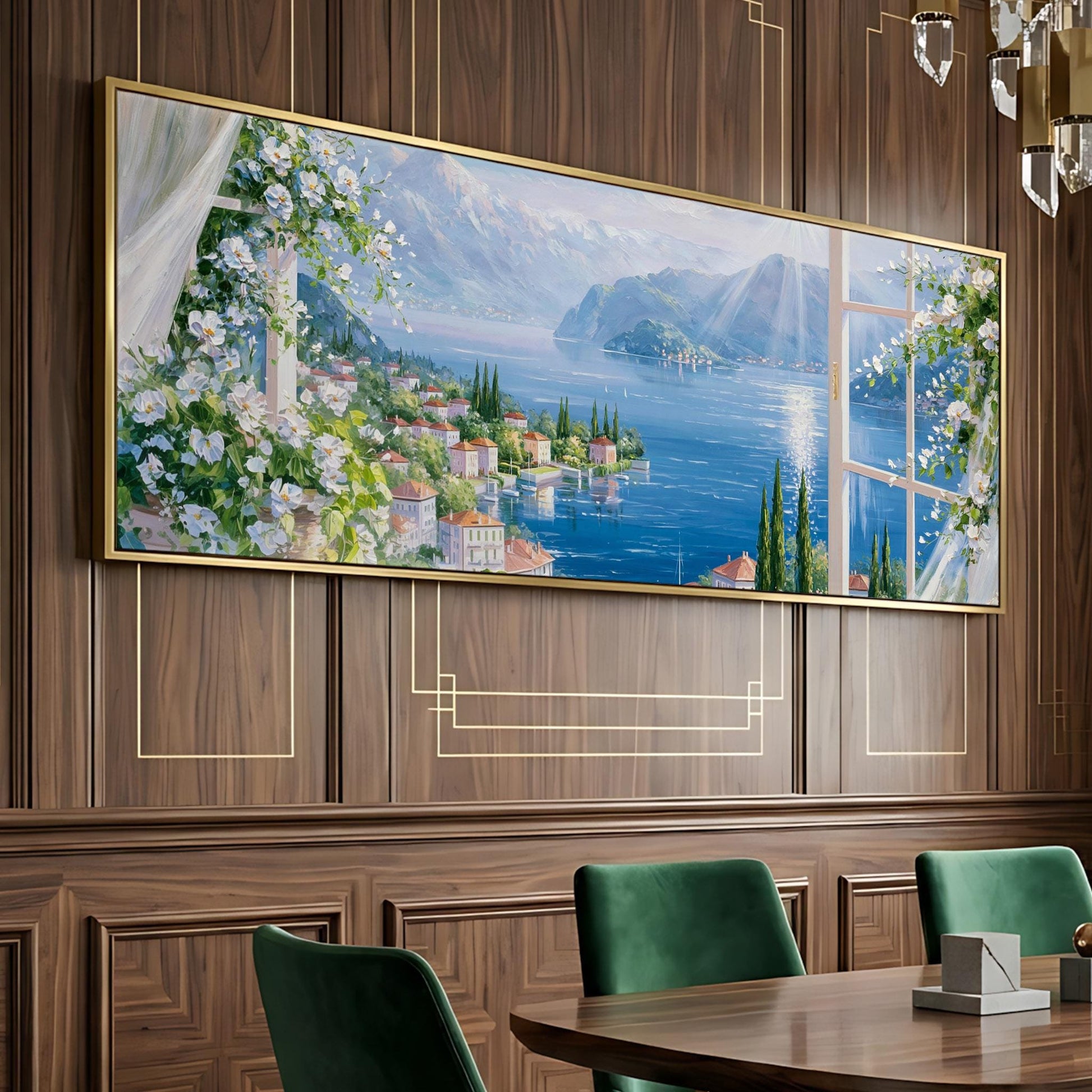 a large painting of a scenic landscape with a river, mountains, and buildings, hanging on a wooden wall above a dining table with green chairs.