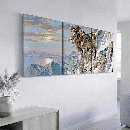 a large painting of a ram on a snowy mountain, hanging on a wall in a room with a vase of flowers on a table.