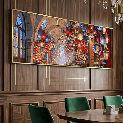 a large, colorful painting of a lantern-filled hallway, hanging on a wooden wall. The painting is framed in gold and is displayed above a wooden dining table with green chairs.