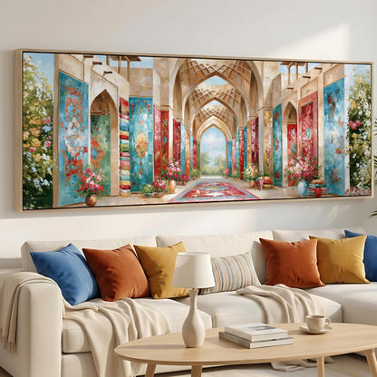 a large, colorful painting of an ornate, arched hallway with floral decorations hanging from the walls. The painting is displayed on the wall above a white sofa with colorful throw pillows.