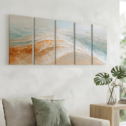 a living room with a large wall art piece depicting a beach scene, including waves and sand. The art piece is composed of six panels, each showcasing different aspects of the beach landscape. The room also includes a couch, a side table with a vase of flowers, and a bookshelf.