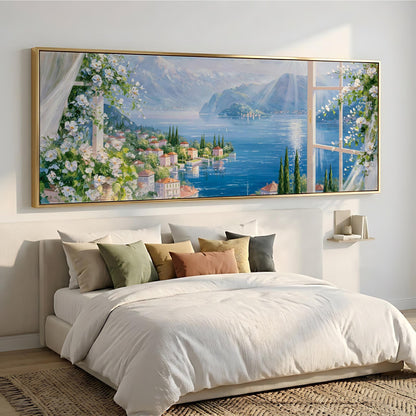 a large, framed painting of a picturesque landscape hanging above a bed with white bedding and pillows.