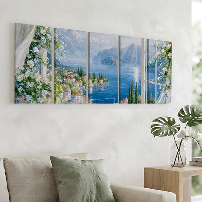a large, four-panel painting of a scenic view of a coastal town with mountains in the background, hanging on a wall above a couch in a living room.
