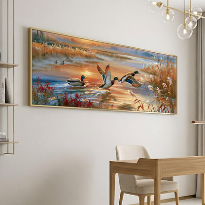 a large painting of ducks flying over a body of water, with a warm sunset in the background.