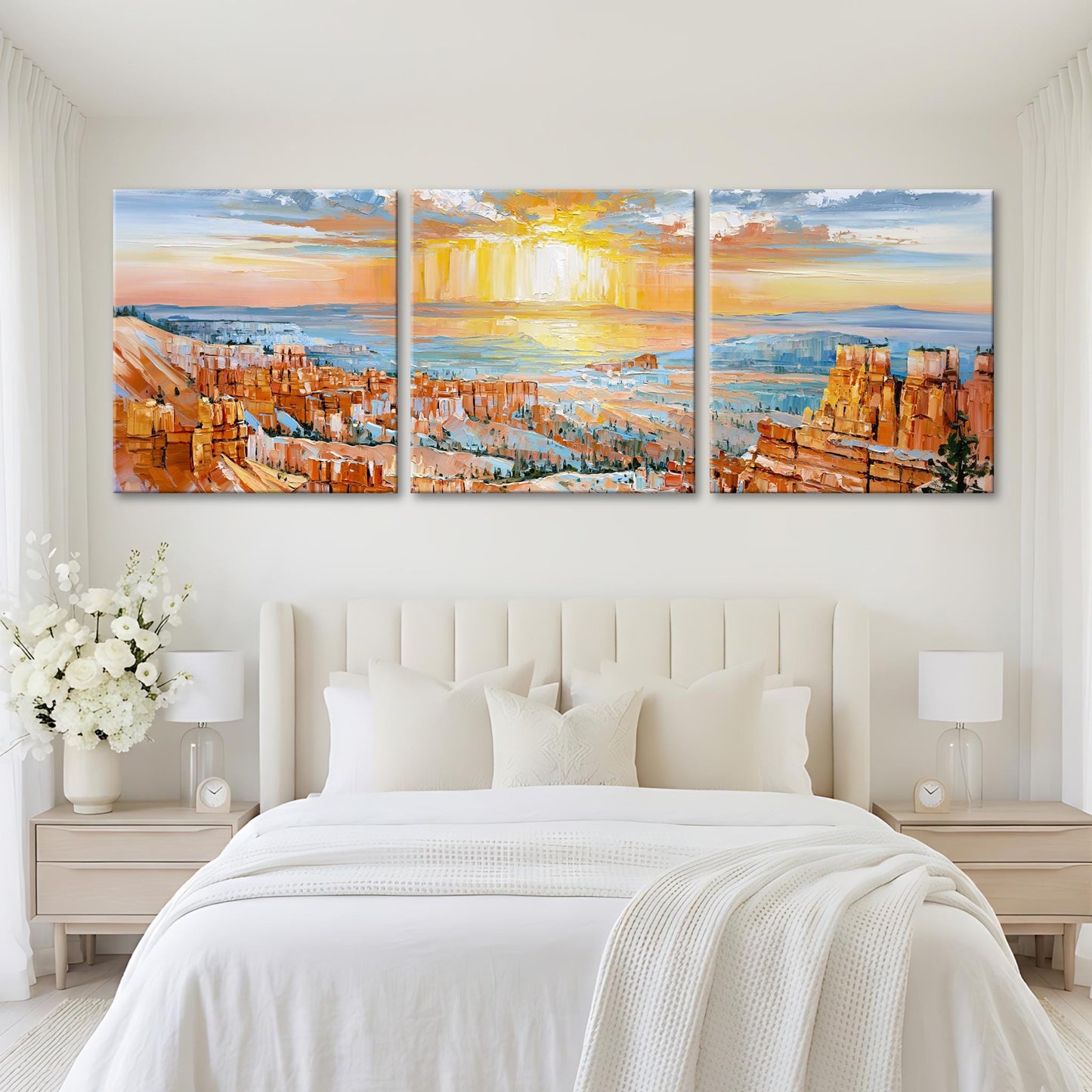 A large, three-panel landscape painting depicting a scenic view of a mountainous region at sunset, with warm hues of orange, yellow, and blue.
