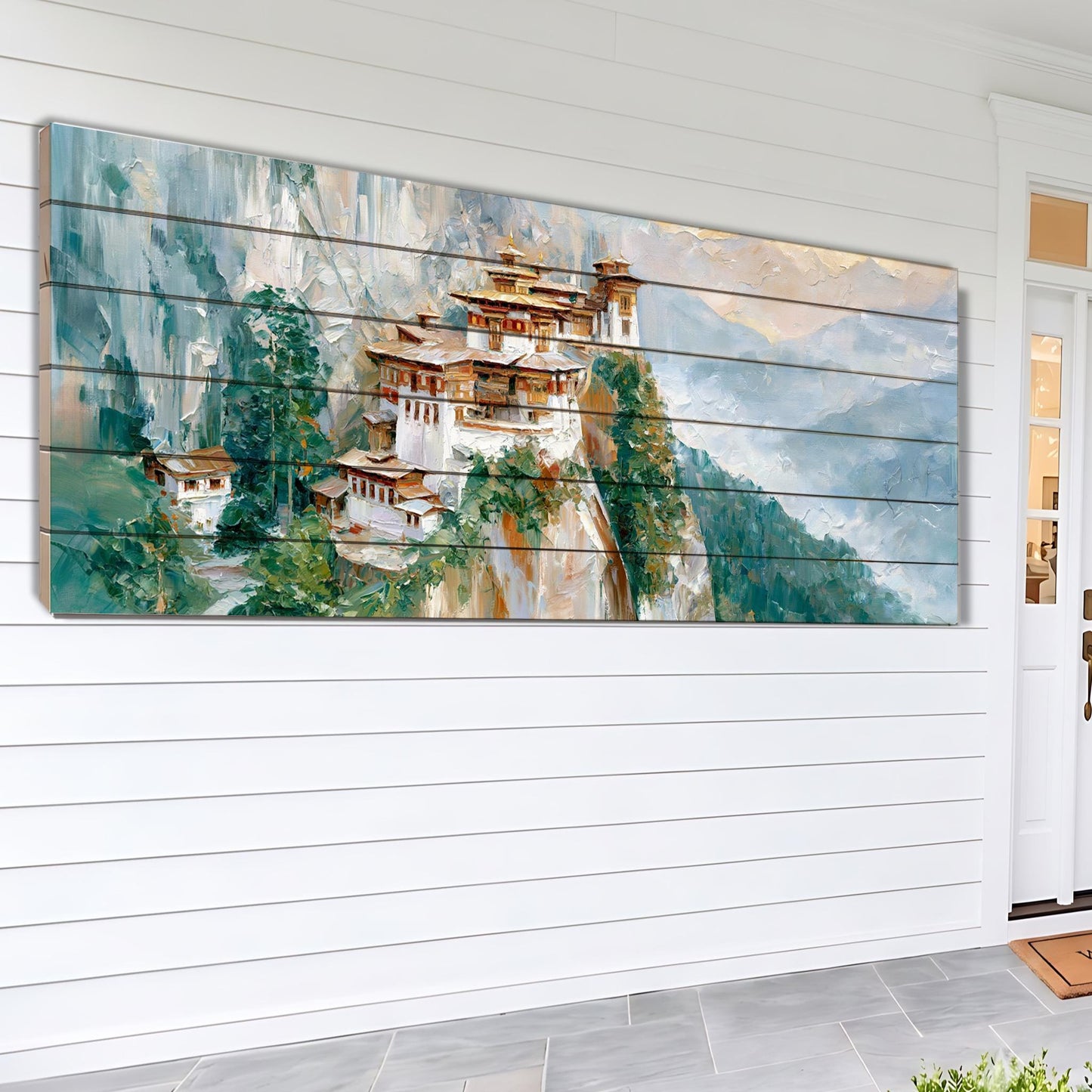 A large painting depicting a mountainous landscape with traditional Chinese-style houses perched on the cliff.