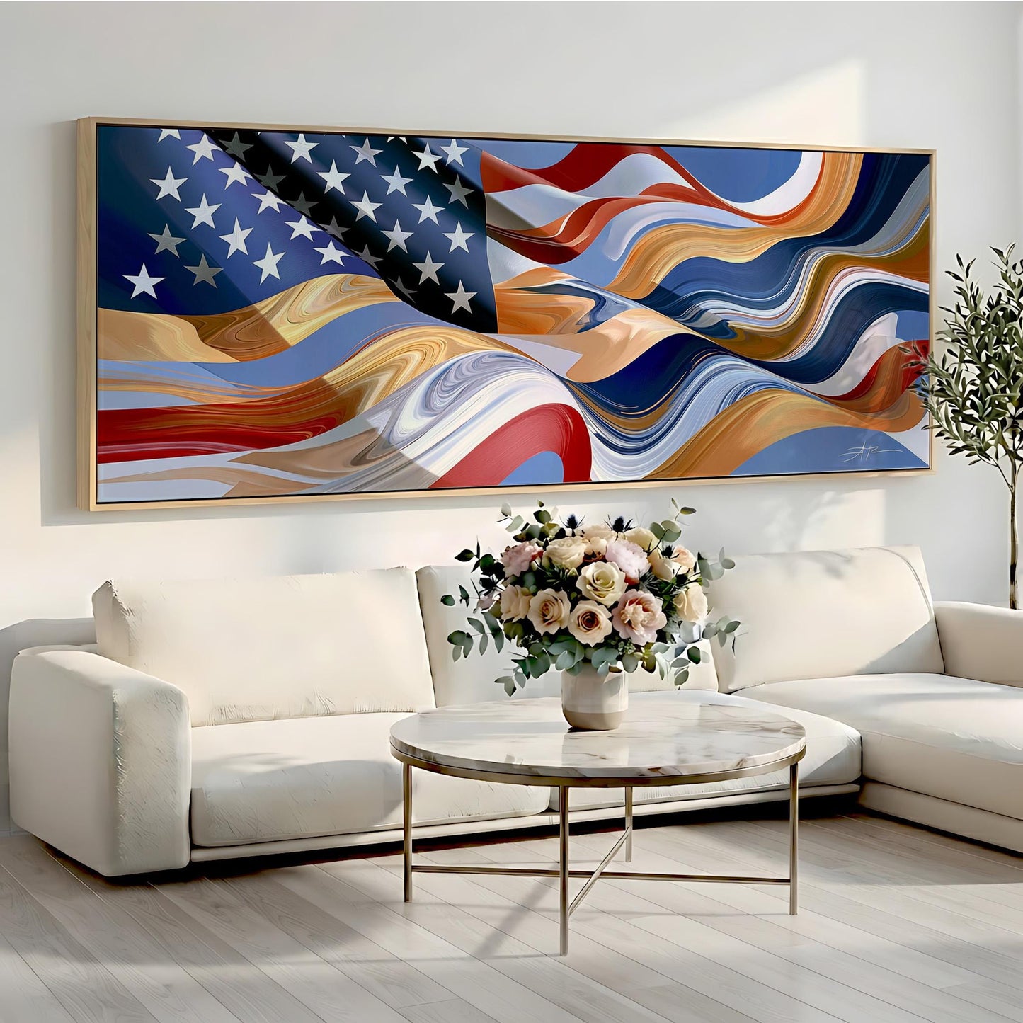 a large, colorful painting of the American flag hanging on a wall above a white sofa and a round coffee table with a vase of flowers.