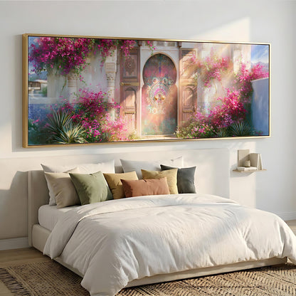 a large, ornate, and colorful painting of a gate or doorway, surrounded by a lush garden with pink flowers, hanging above a bed with white linens and pillows.