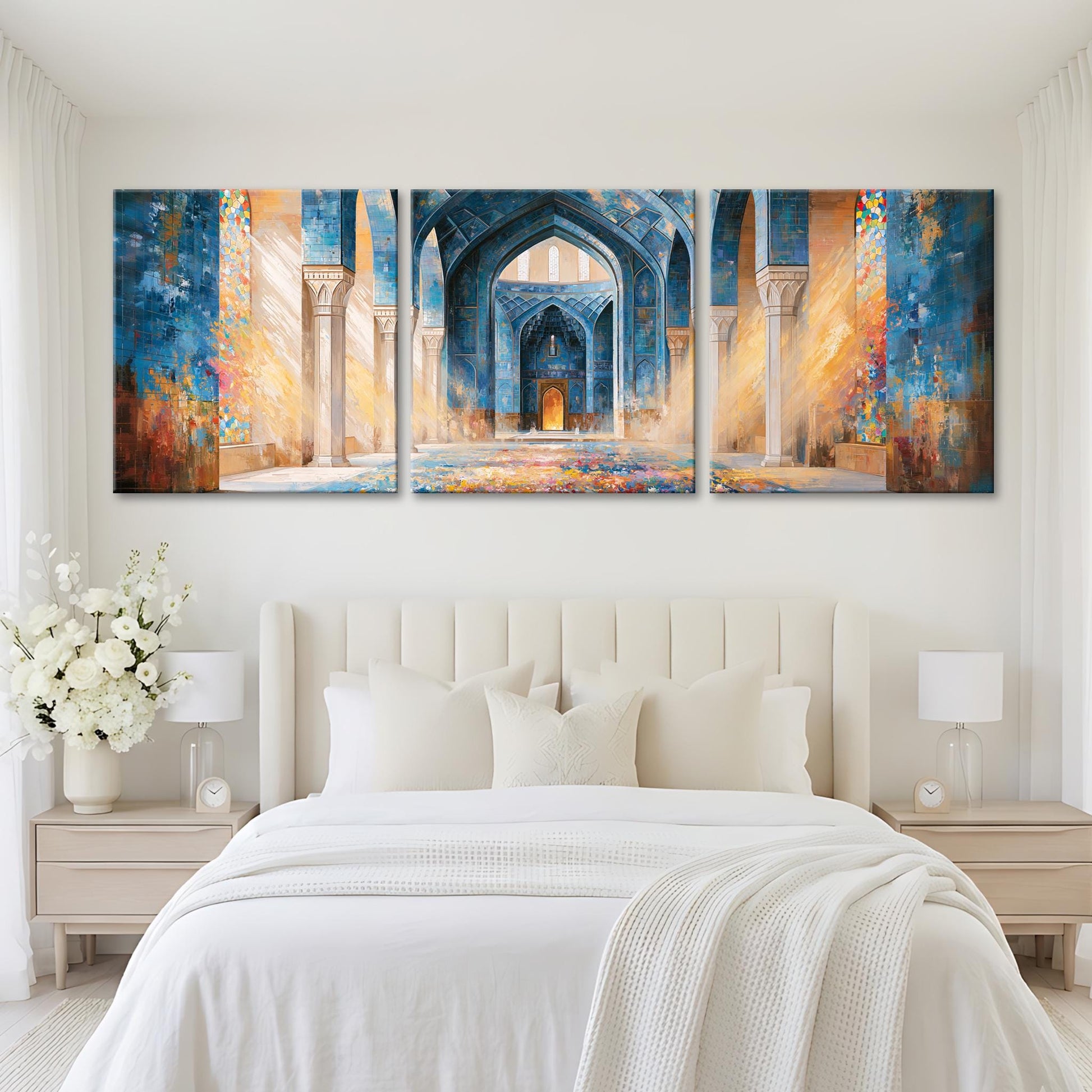 A large, three-panel painting depicting an ornate, colorful archway in a mosque, hanging above a bed with white bedding and pillows.
