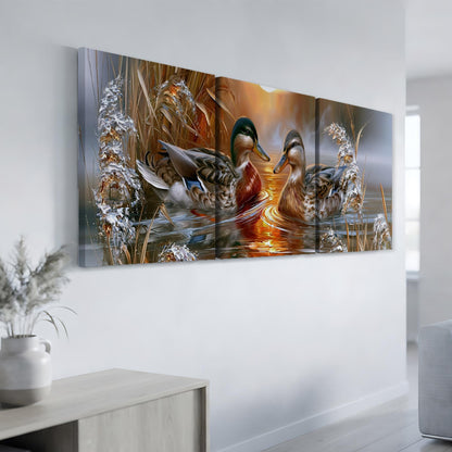 a large, three-panel painting of ducks swimming in a pond, with a warm, golden sunset in the background.
