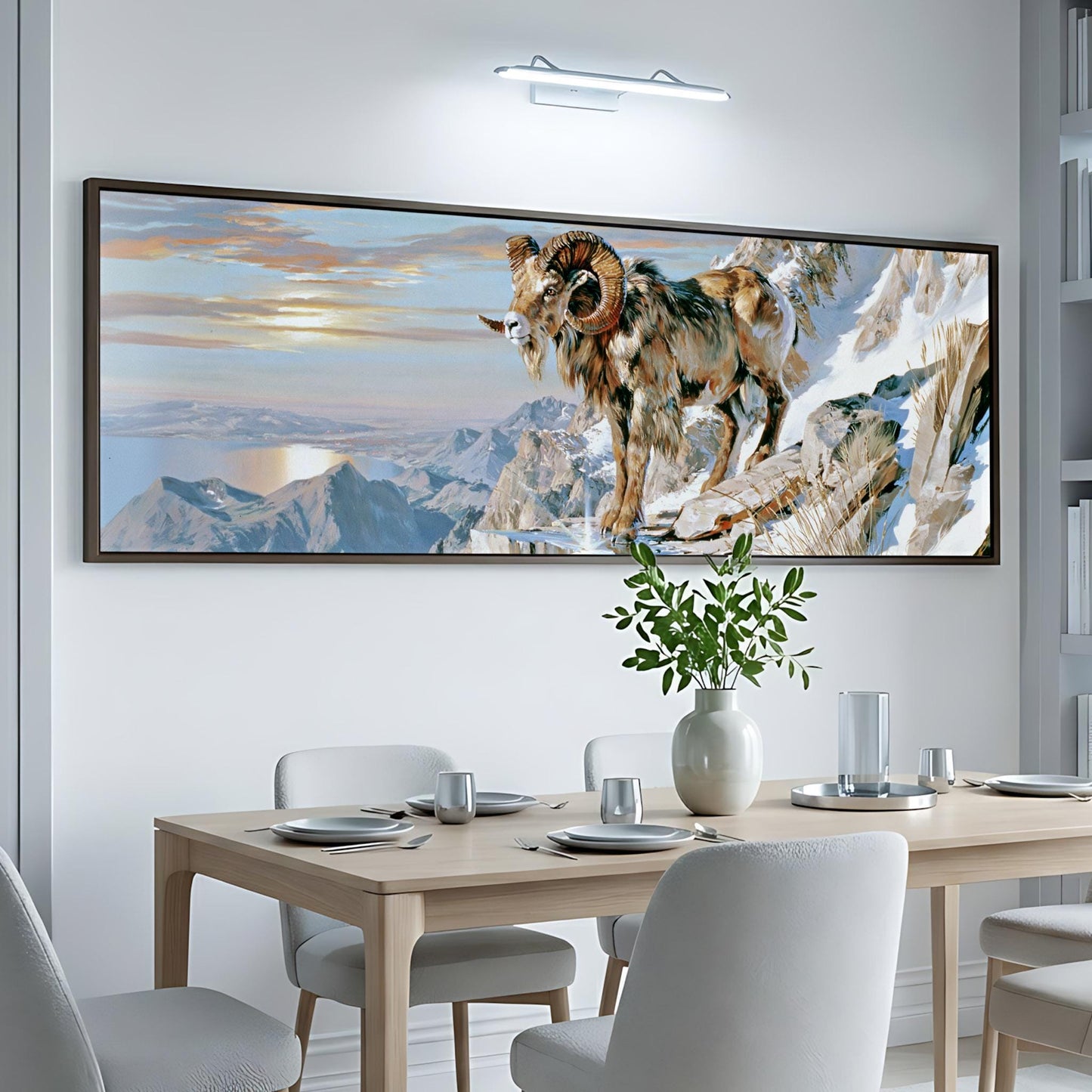 a large, framed painting of a ram standing on a snowy mountain, with a serene landscape in the background.
