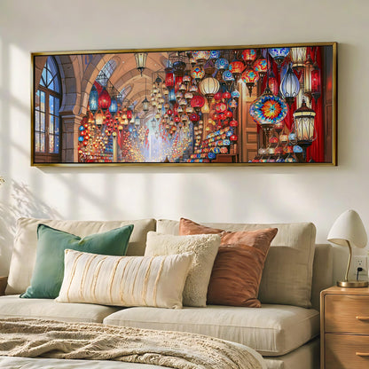 a large, colorful painting of a lantern-filled hallway hanging on a wall above a beige couch with various pillows.