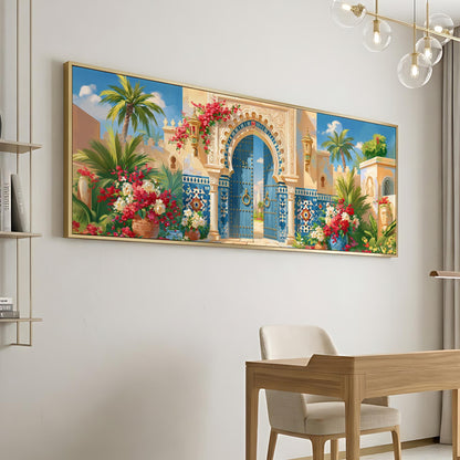 a large, colorful painting of an ornate, arched doorway with a blue gate, surrounded by tropical plants and flowers. The painting is hung on a white wall above a wooden desk and chair, creating a visually appealing and vibrant atmosphere in the room.