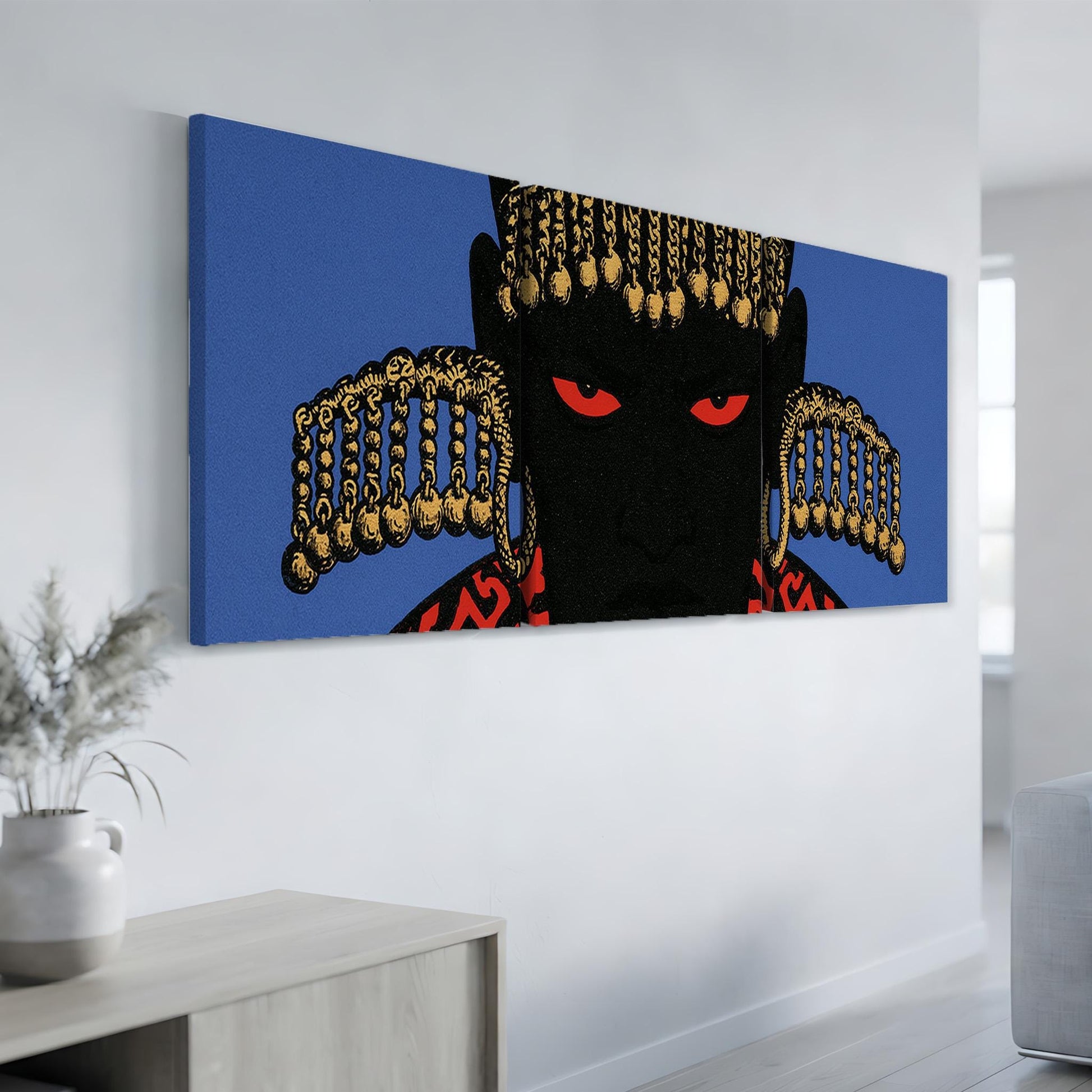 a large, colorful painting of a person's face with striking red eyes and a black background, hanging on a wall in a room.