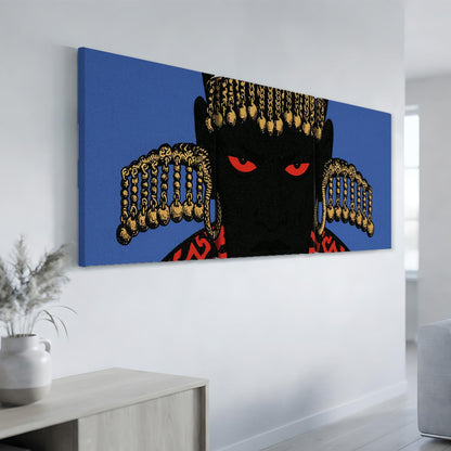 a large, colorful painting of a person's face with striking red eyes and a black background, hanging on a wall in a room.