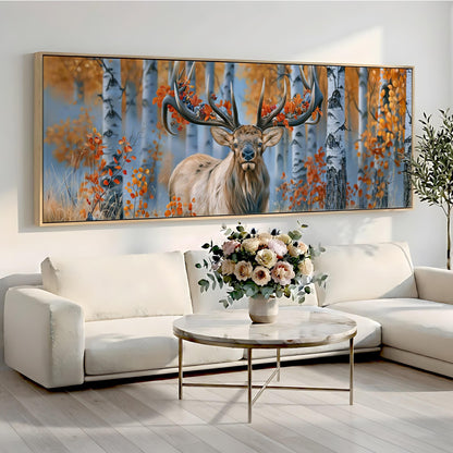 a large painting of a deer with antlers, displayed on a wall above a white sofa and a round coffee table with a vase of flowers.
