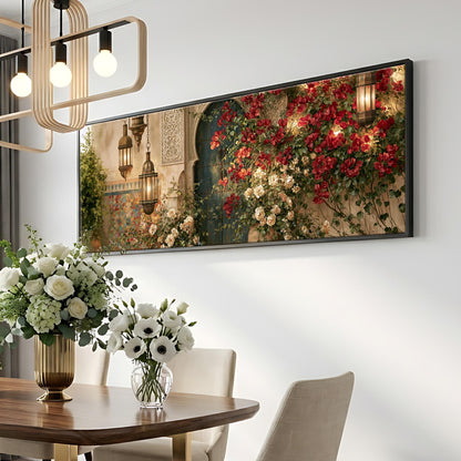 a dining room with a large floral painting hanging on the wall above a wooden table. The table is set with a vase of white flowers and a potted plant. The room has a modern and elegant design, with a chandelier and a white wall.