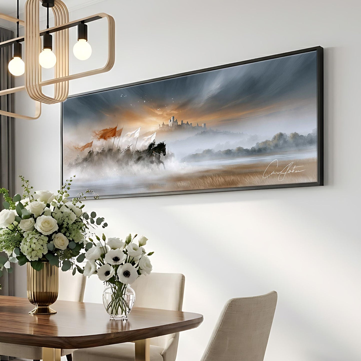 a large painting of a landscape with a horse and a castle in the distance, hanging on a white wall above a wooden dining table with a vase of white flowers.