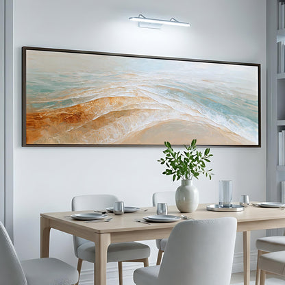 a dining room with a large, colorful painting hanging on the wall above a table set for a meal.