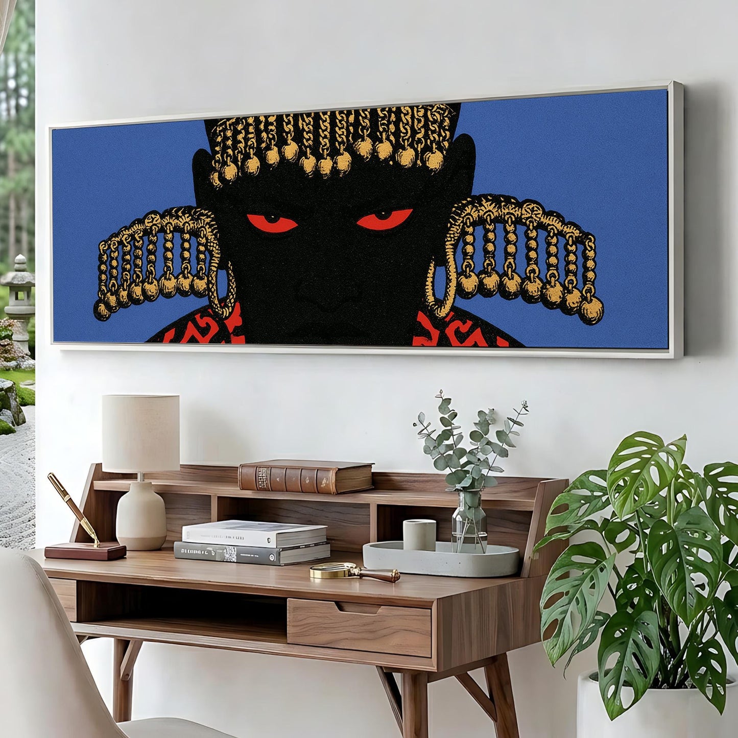 a large, colorful painting of a black figure with gold accents, displayed on a wall above a wooden desk with various items on it.