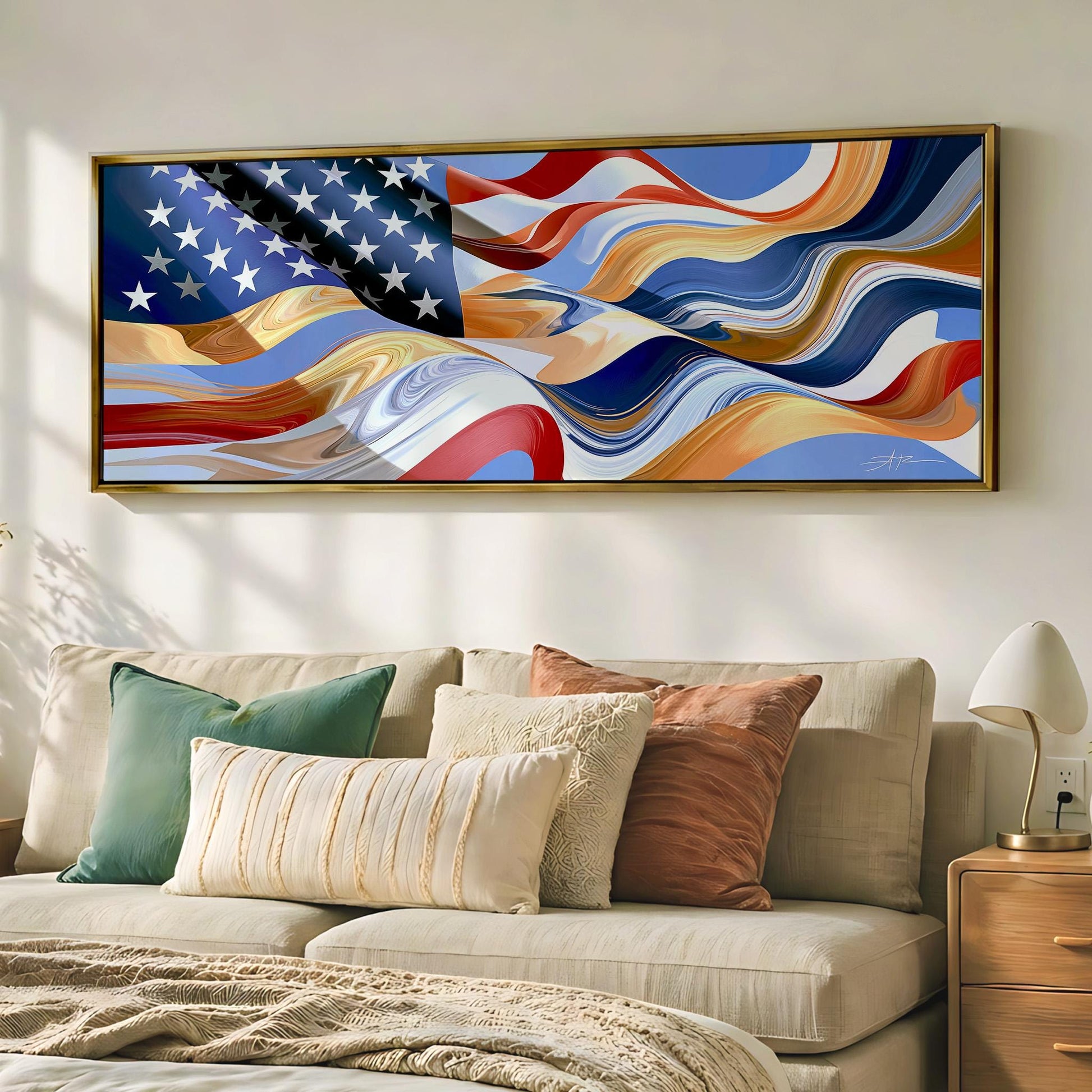 a large framed artwork of the American flag hanging on a wall above a beige couch with various throw pillows.