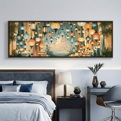 a bedroom with a large bed, a nightstand, and a desk with a lamp. The bed has white linens and blue pillows. The nightstand has a lamp and a plant. The desk has a lamp and a book. The wall behind the bed has a large painting of hanging lanterns.
