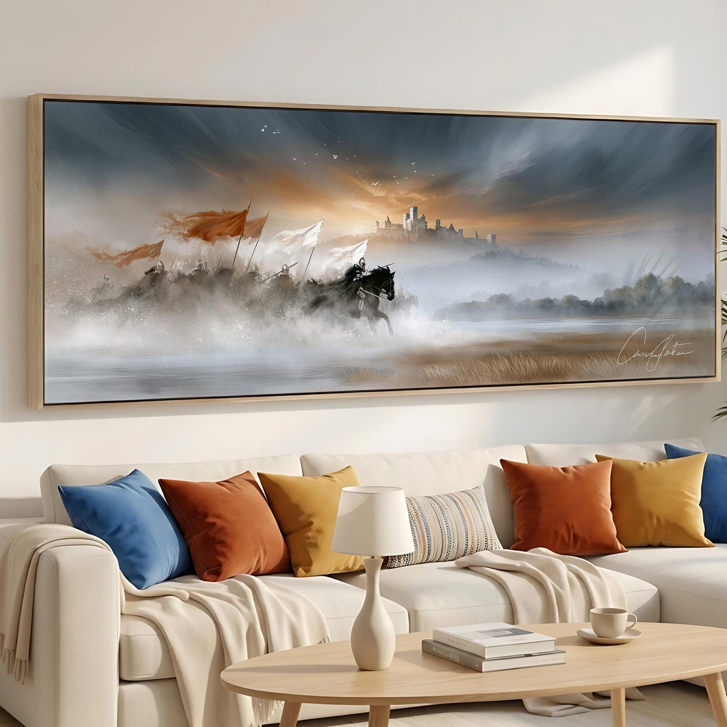 a large, colorful painting of a landscape with a castle in the background, hanging on a wall above a white couch with colorful throw pillows.